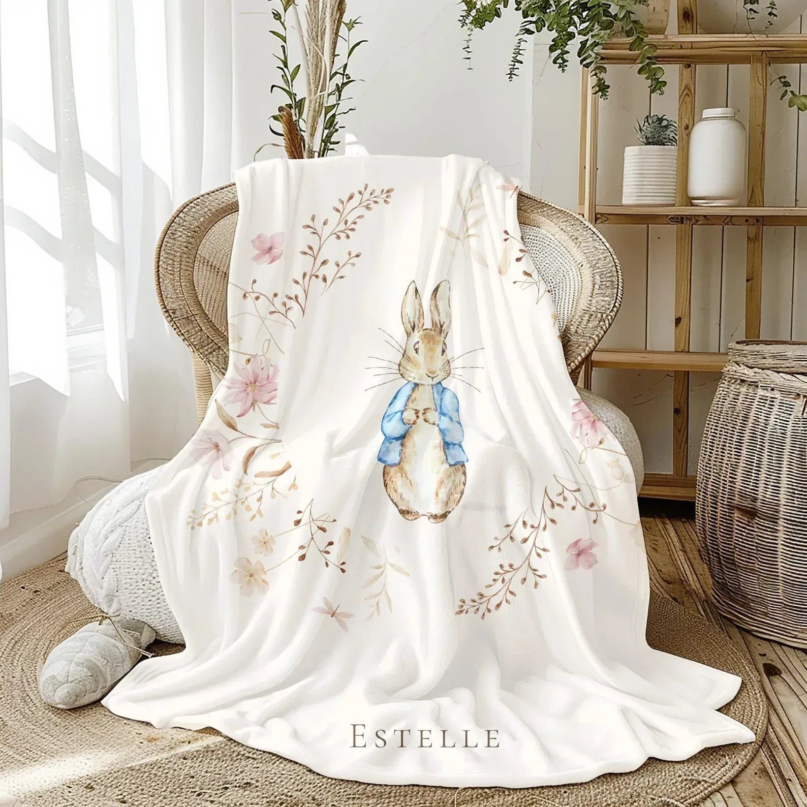 Custom child's name detail on Peter Rabbit storybook-themed nursery blanket.