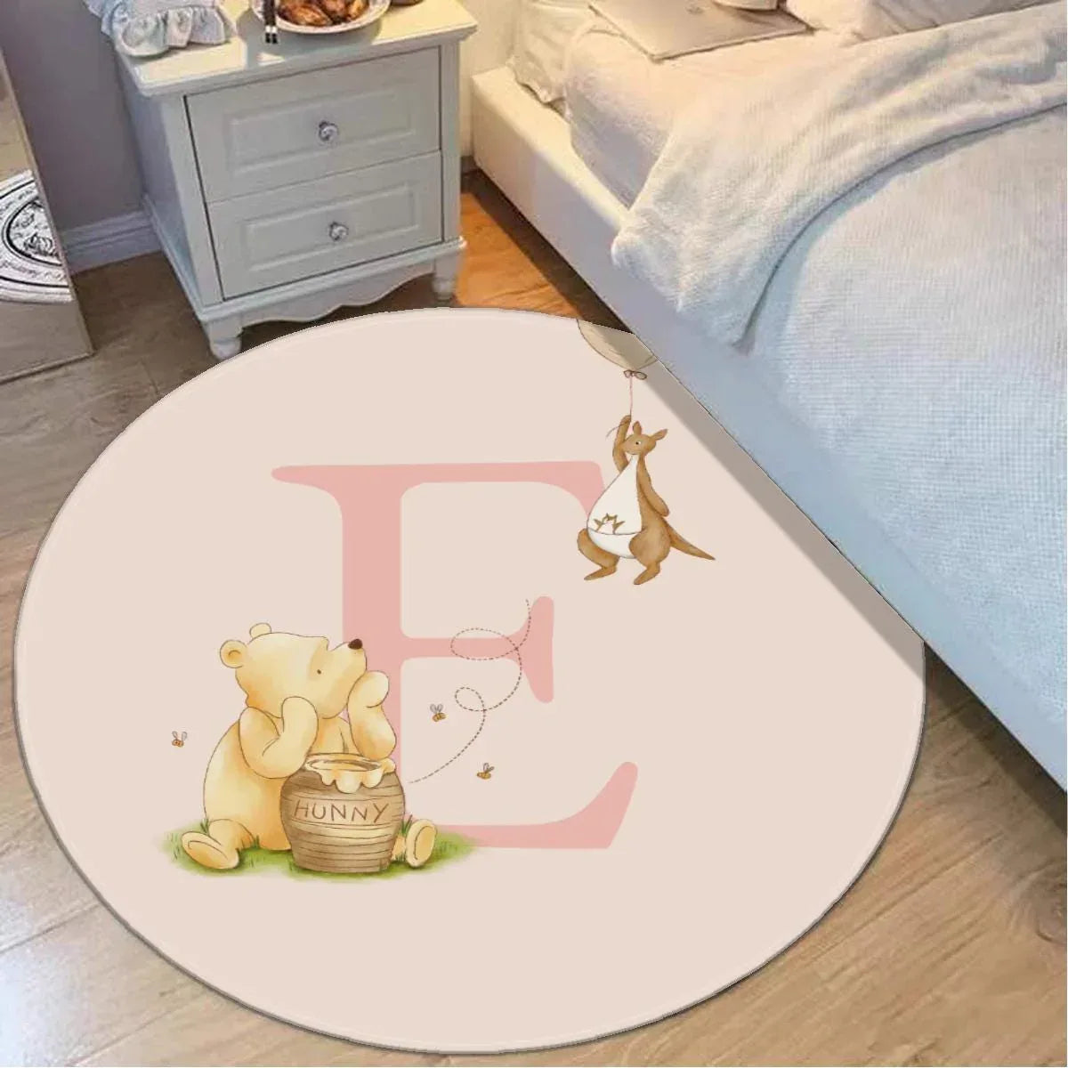 Close-up of Pooh and Roo character illustration on soft nursery floor mat.