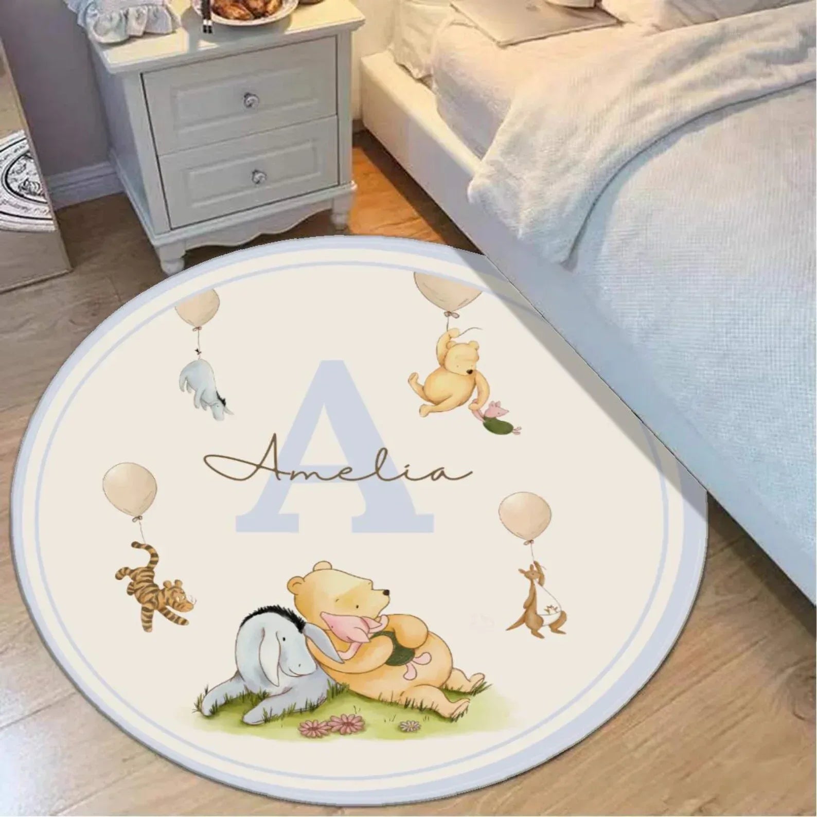 Custom name detail on Winnie the Pooh baby rug, perfect personalized keepsake for nursery or playroom.