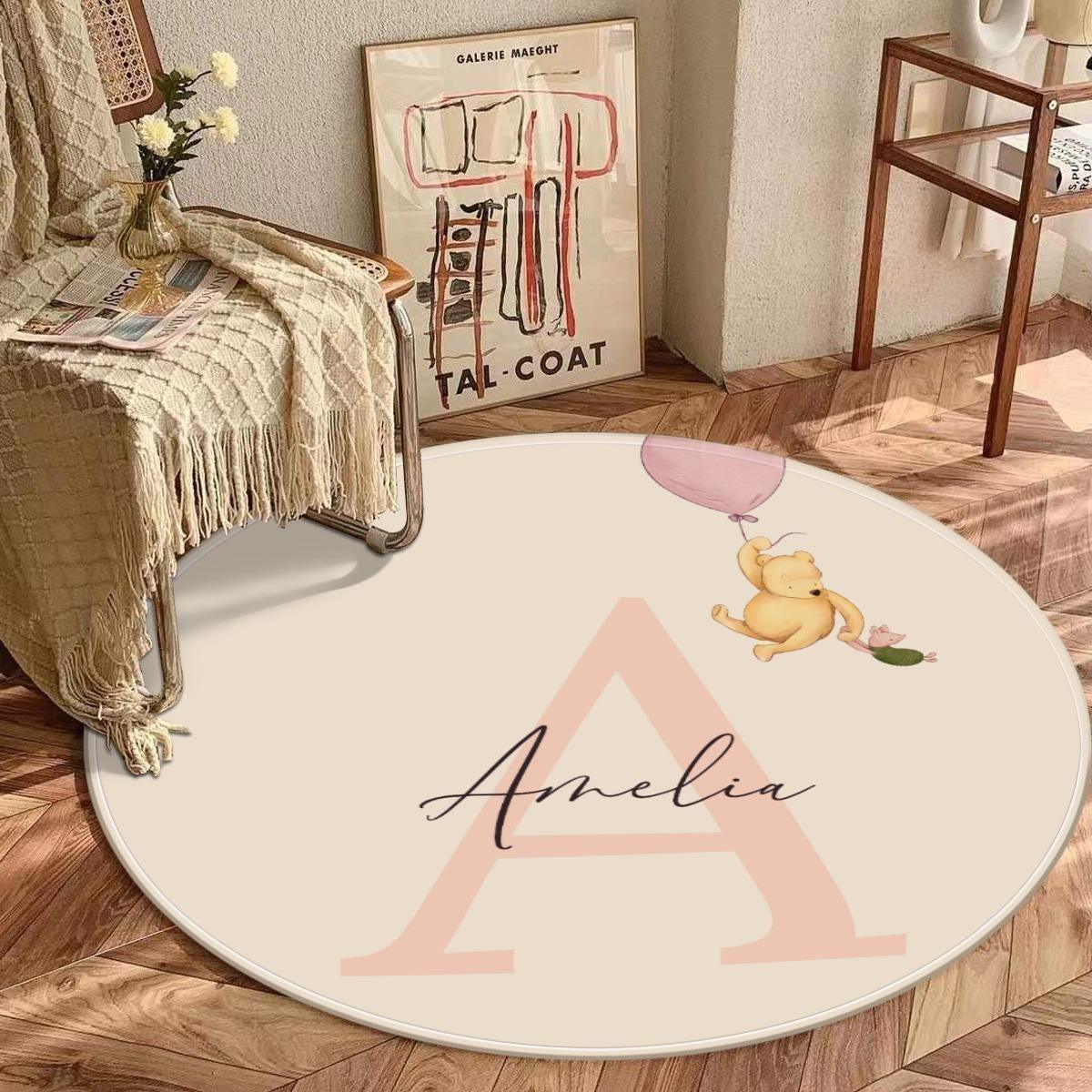 Close-up of custom initial detail on Winnie the Pooh balloon nursery rug.