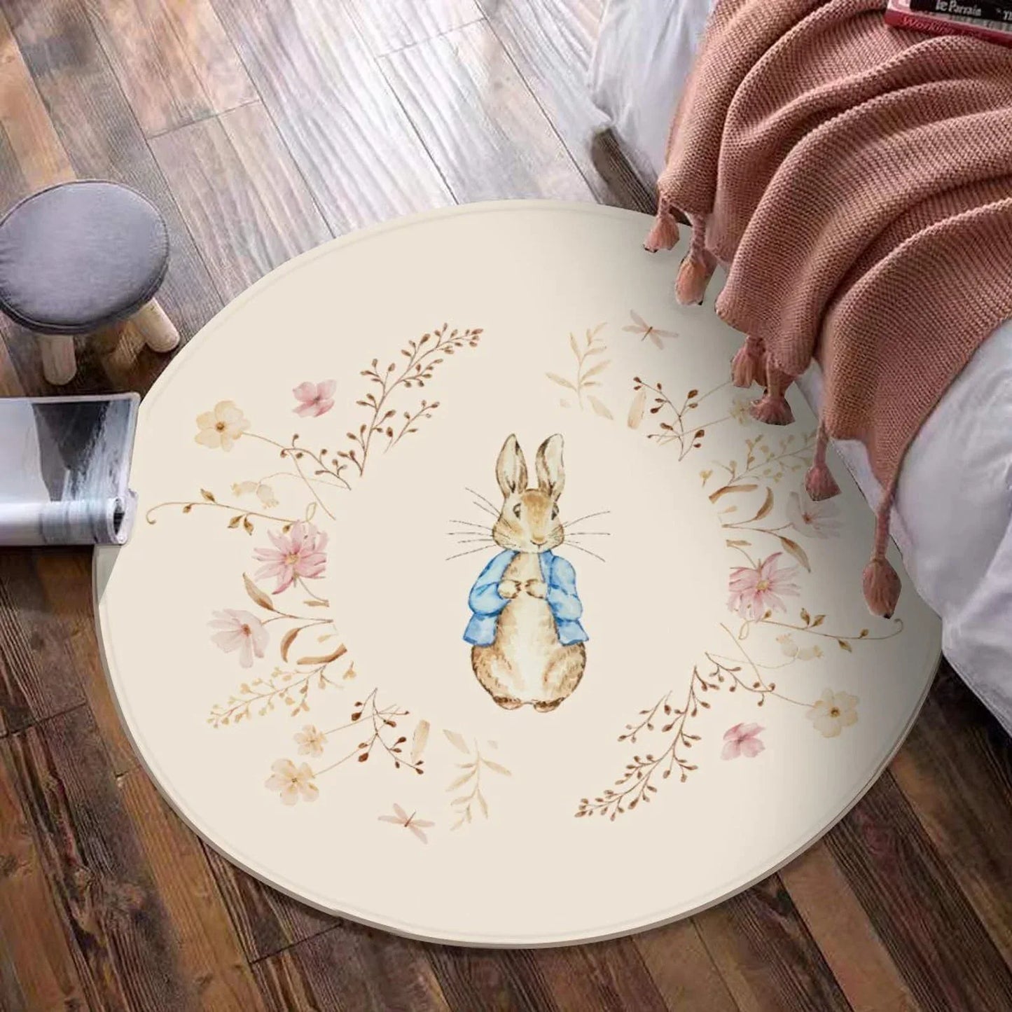 Close-up of delicate floral and bunny pattern on soft round nursery rug.