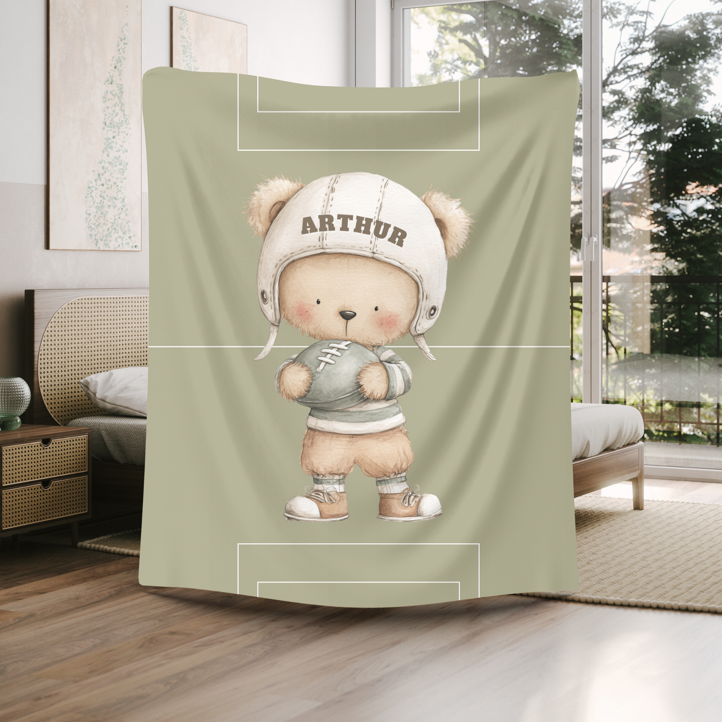 Custom name detail on personalized football nursery blanket gift.