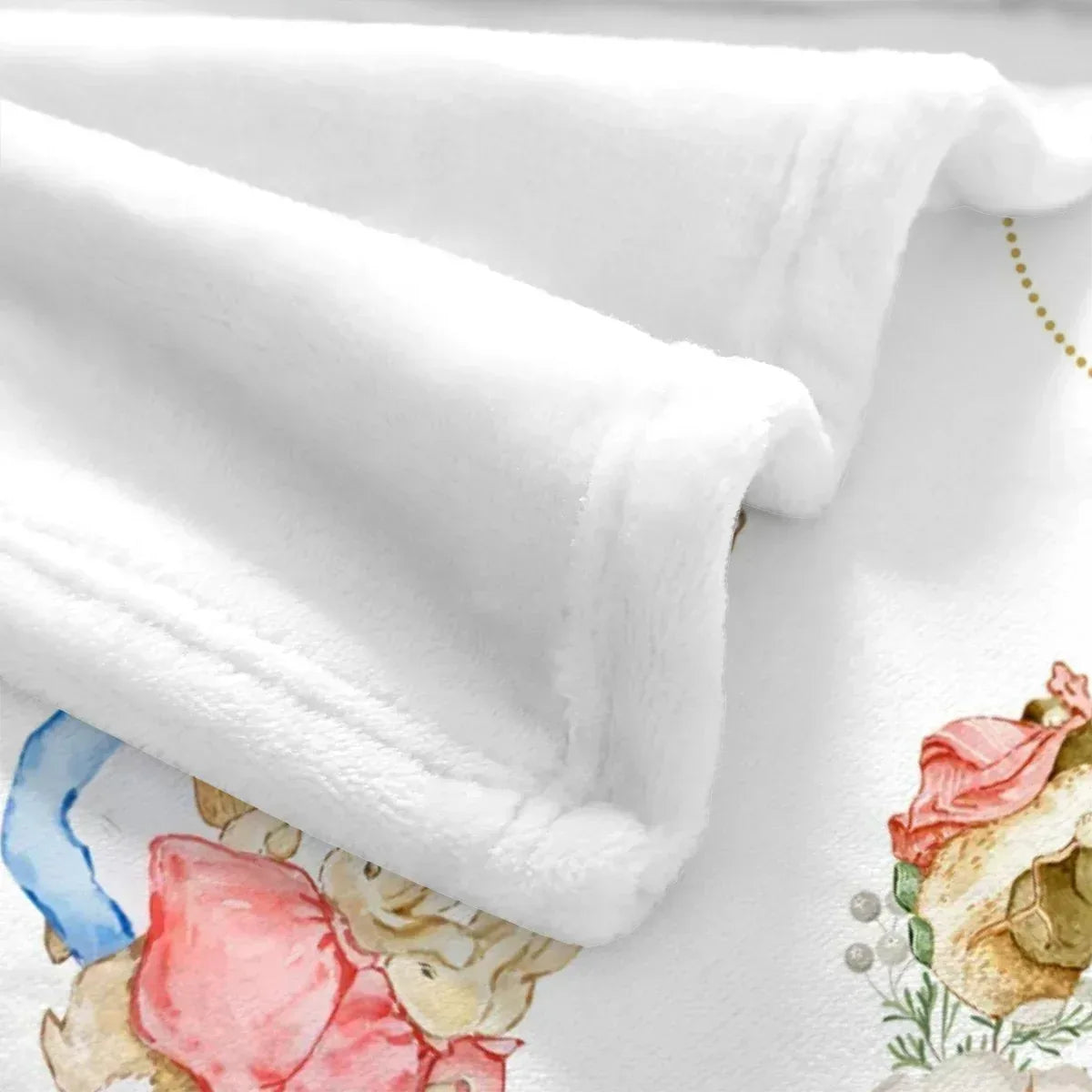 Detail view of vintage bunny and friends print on buttery-soft nursery baby blanket.